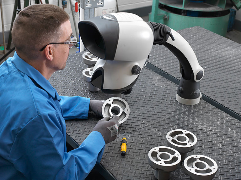 Mantis Classic stereo microscope being used for deburring metal part in workshop