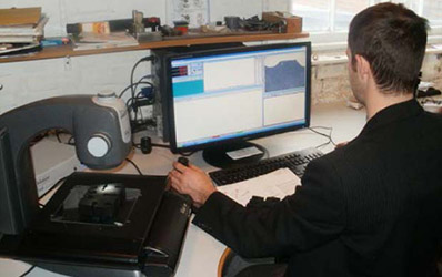 Operator inspecting rubber components with video measuring system